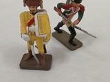 three toy soldiers that are standing in the snow