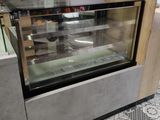 a glass display case in the middle of a store