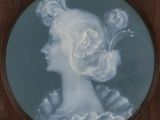 portrait of a woman in a blue dress with a flower in her hair