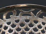 a close up view of a metal chair with holes in it