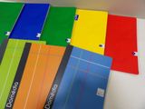 a lot of different colored notebooks on the table