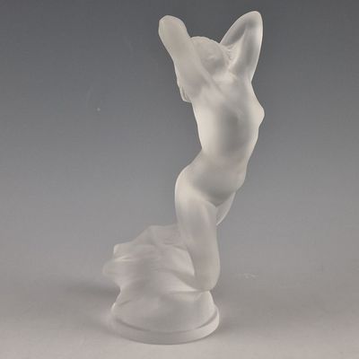 statue of a woman with a hat on her head on a white base