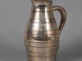 a silver pitcher that is sitting on a table