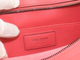 the inside of a pink bag with a hand holding it