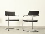 pair of chrome and black leather cantile chairs