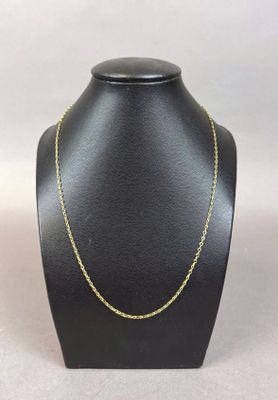 a black mannequin with a gold chain on it