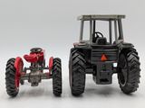 a red tractor and a black tractor on a white background