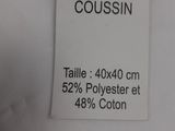 a label on a white shirt that says house de coussin