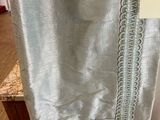 a curtain hanging on a table with a price tag on it