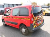 a red van that is parked in a parking lot