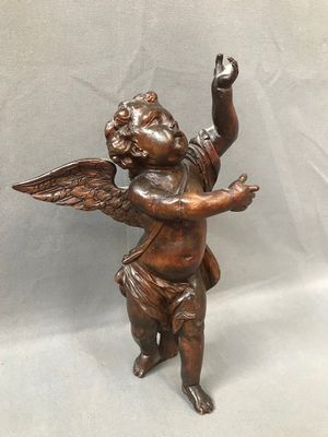 a bronze statue of an angel holding a dove
