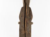 a wooden statue of a man with a hood on his head