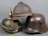 two helmets are sitting next to each other on a gray surface