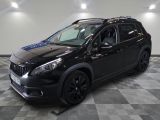 the black car is parked in the garage on the checkered floor