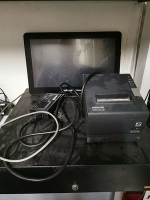 a laptop computer sitting on top of a desk with a printer on top of it
