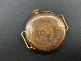 gold plated pocket watch with arabic calligraphy on the dial