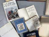 several books on a table that are sitting on top of each other