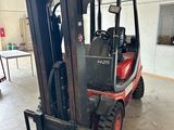 un chariot élévateur garé dans un entrepôt dont la porte est ouverte