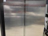 two stainless steel refrigerators in a warehouse area