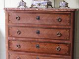 a wooden dresser with a marble top in a room