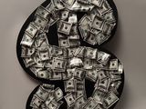 a close up of a dollar sign made out of money on a table