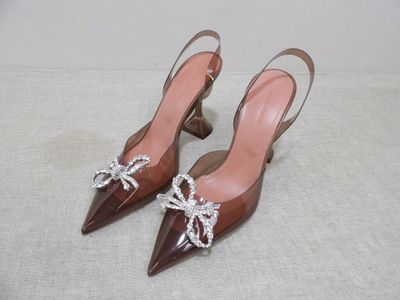 pair of women ' s brown shoes with bows on the toes