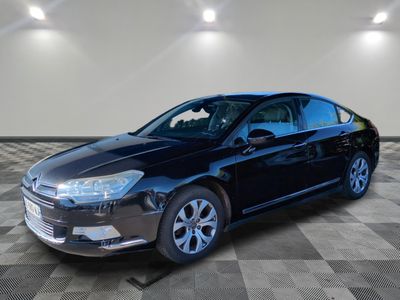 the black car is parked on a checkered floor in the garage