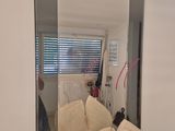 a large mirror in the corner of a bathroom