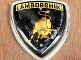 a close up of a lamb logo on a wooden surface