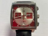 a close up of a watch on a white surface