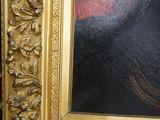 painting of a black cat with a red background in a gold frame