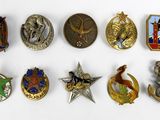 a lot of badges that are on a white surface