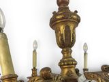 a gold chandelier with three candles on it