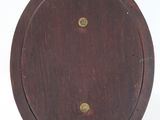 wooden clock with brass fittings on a stand on a white background