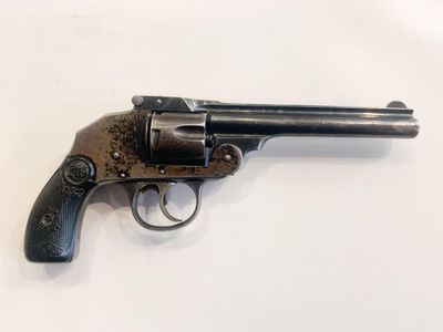 a small revolver with a wooden handle on a white surface