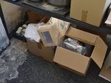 many boxes of items on a shelf next to a wall