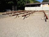 a lot of wooden benches in the middle of a parking lot