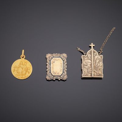 three gold and silver pendants and a gold coin