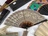 many different types of hand fans on a table