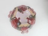 a glass bowl with figurines in it on a table