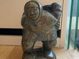 a statue of a man carrying a child on his back