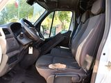 the interior of a white van with the driver ' s seat down
