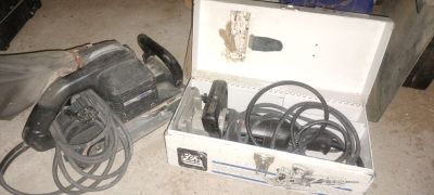 a box with a drill and other tools on the floor