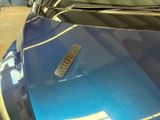 a remote control on the hood of a blue car