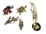 four pieces of jewelry including a turtle, an elephant, and a turtle
