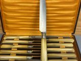 six knives in a case on a table