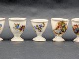 six small vases are lined up in a row on a table