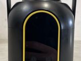 an image of a black and yellow speaker sitting on top of a table