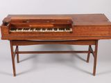 an old wooden piano with a keyboard on top of it