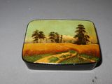 a small box with a painting on it on a table